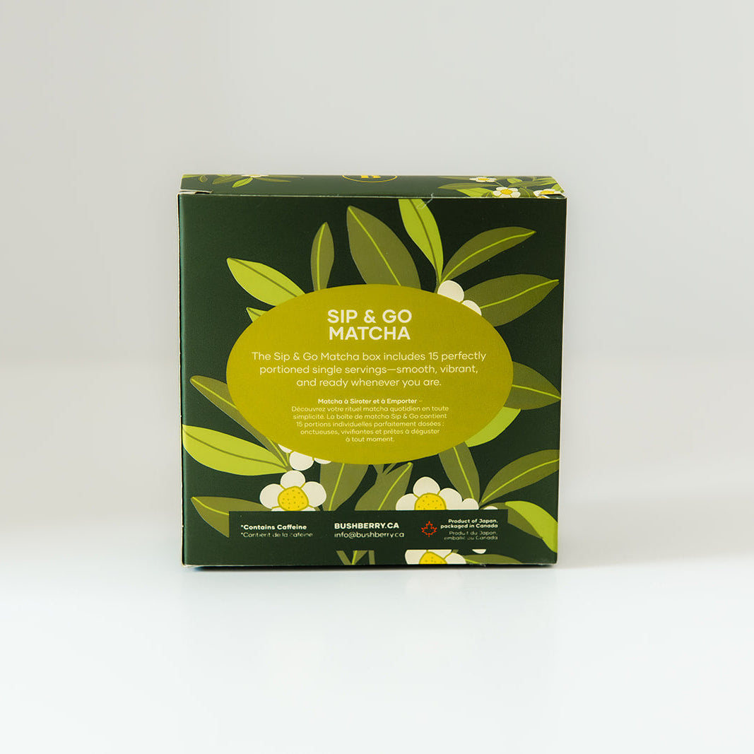 A square box of Sip & Go Matcha tea, featuring a dark green background decorated with illustrations of green leaves, white flowers, and a large yellow-green oval label in the center.