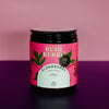 Jar of Bush Berry Elderberry on a pink and purple gradient background